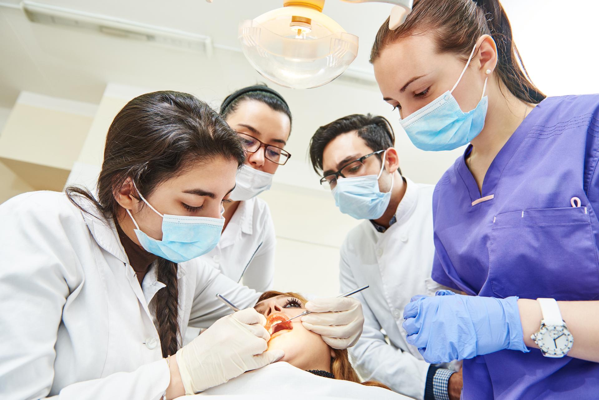 Female dentist doctor teaching students