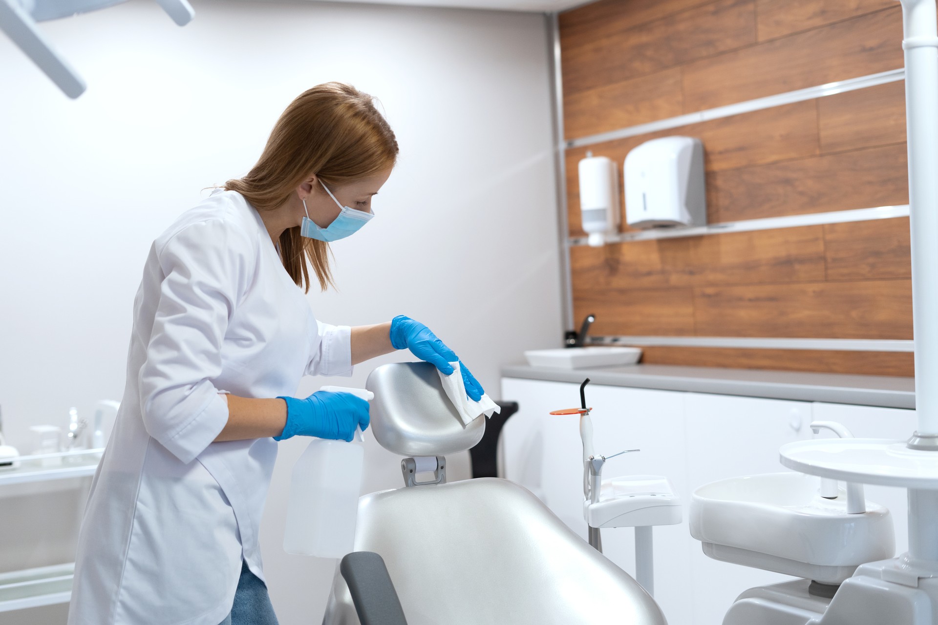 Nurse disinfect dental chair in stomatology clinic