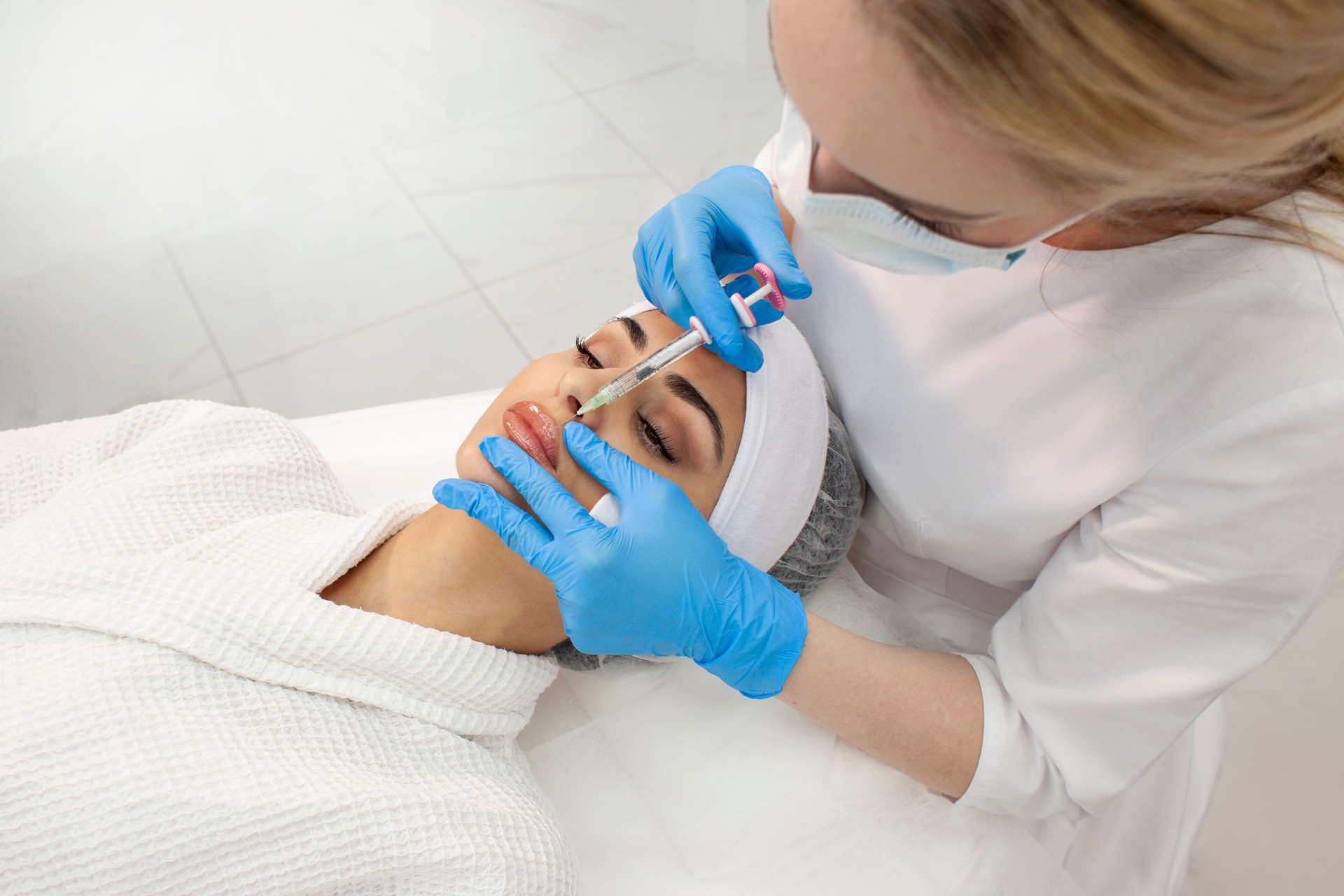 lip augmentation procedure using botox in cosmetology clinic, cosmetologist doctor in gloves makes injection