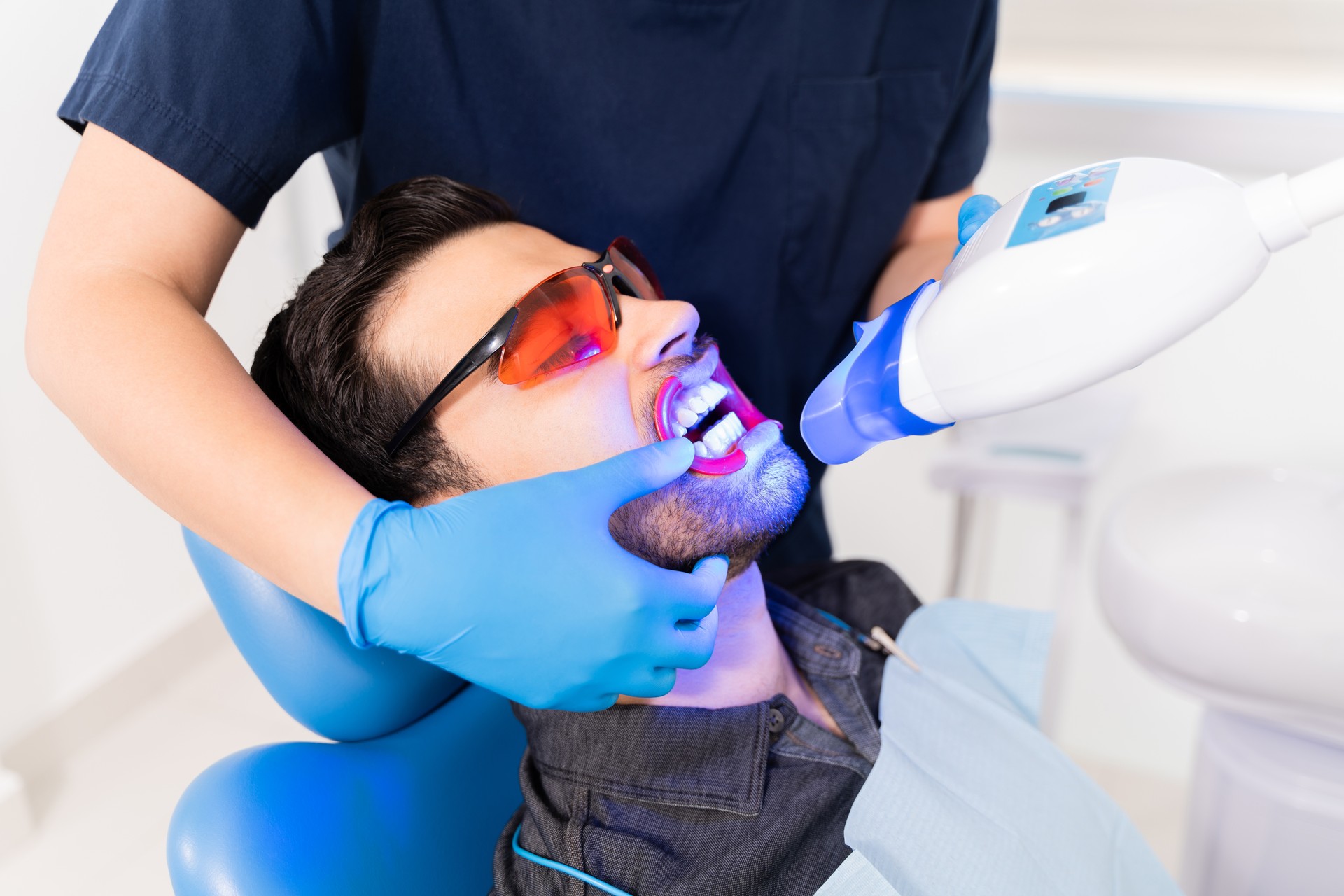 Close up of an attractive patient getting a whitening laser treatment